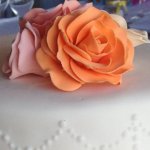 Celebrate Cakes Sugar Flowers - Full sugar roses in an orange and coral colour palate