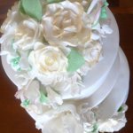 Celebrate Cakes Sugar Flowers - cascade of blossoms including gold tipped sugar roses, sugar orchids and filler blossoms and greenery